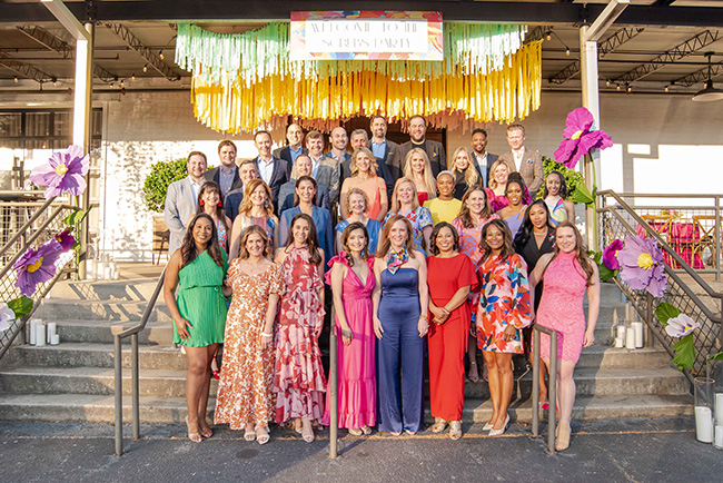 leadership group of men and women smiling at a fundraising event