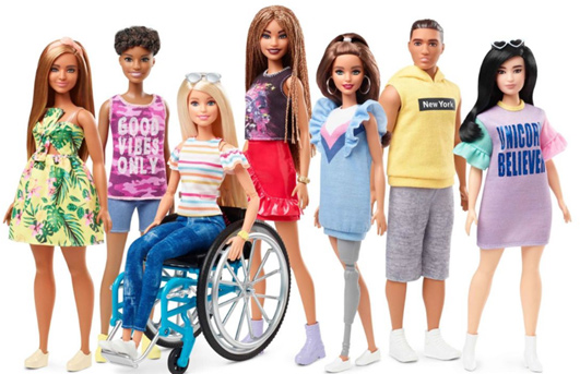 a number of Barbie Dolls lined up with prosthetic limbs and scoliosis b