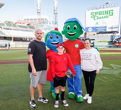 Gavyn and parents pose with Hope and Will at Spring Classic game.