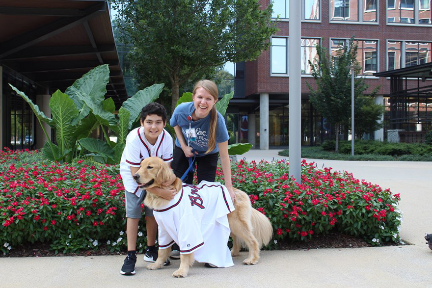 Aflac patient Jaxx with dog and staff member